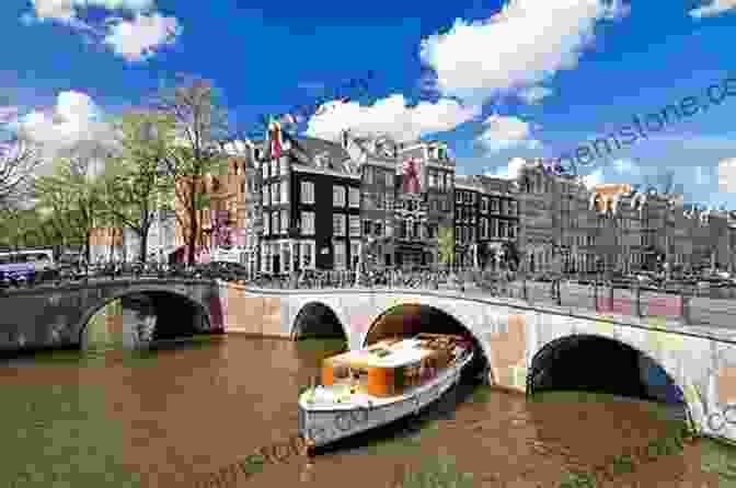 A Boat Glides Through The Picturesque Canals Of Amsterdam, Passing Charming Bridges And Stately Gabled Houses. Amazing Boat Journeys (Lonely Planet)