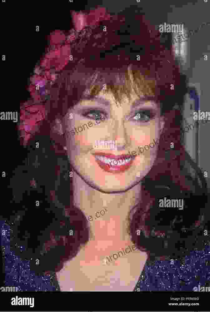 A Portrait Of Naomi Judd, Smiling And Wearing A Red Dress. THE BIOGRAPHY OF NAOMI JUDD: THE LIFE AND TIME OF NAOMI JUDD A MOTHER MUSICIAN AND ACTRESS