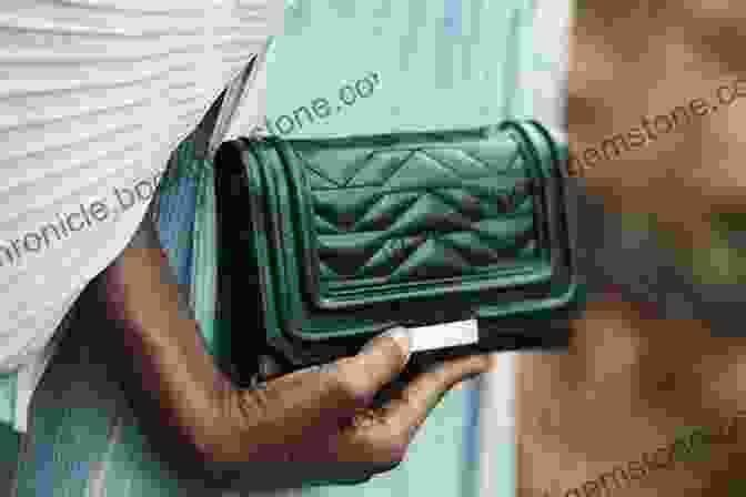 A Woman Holding A Black Leather Clutch Bags: The Modern Classics: Clutches Hobos Satchels More